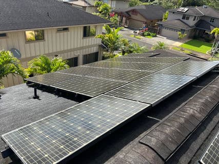 Solar panels installed on a residential roof, showcasing renewable energy solutions in a neighborhood.